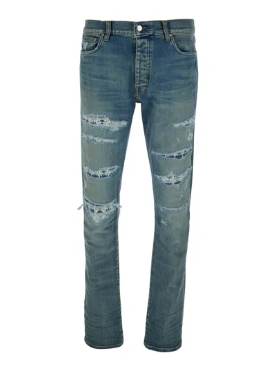 AMIRI BLUE MA QUAND JEANS WITH RIPPED DETAILS ON THE FRONT AND LOGO PATCH ON THE REAR IN DENIM MAN
