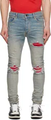 Amiri Mx1 Slim Fit Jeans With Distressed Red Accents In Antique Indigo