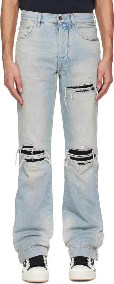Amiri Men Light Bliue Jeans With Flared Leg And Ripped Details In Denim Man In Blue