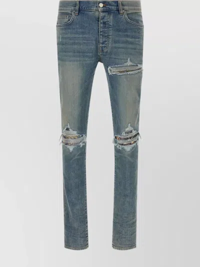 AMIRI DISTRESSED FIVE-POCKET DENIM TROUSERS