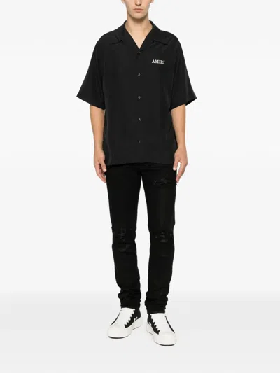 Amiri Distressed-effect Coated Jeans In Black