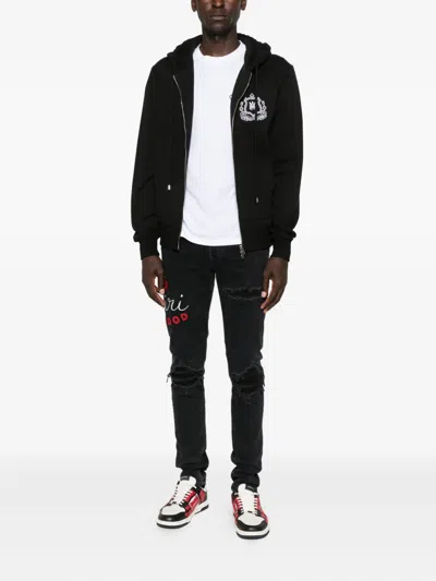 Amiri Embroidered Distressed Jeans In Black