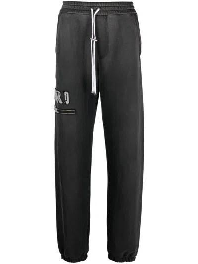 Amiri Logo-appliqué Cotton Track Pants In Schwarz
