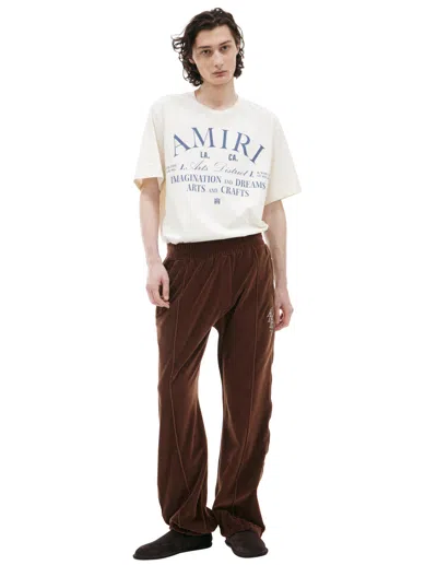Amiri Logo Velour Trousers In Brown