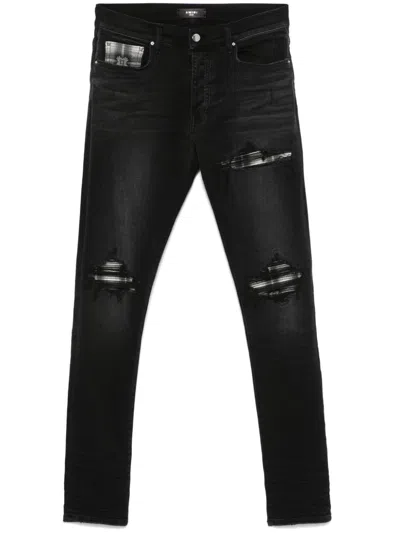 AMIRI RIPPED-DETAILING JEANS