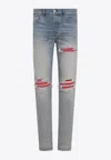 Amiri Mx1 Slim Fit Jeans With Distressed Red Accents