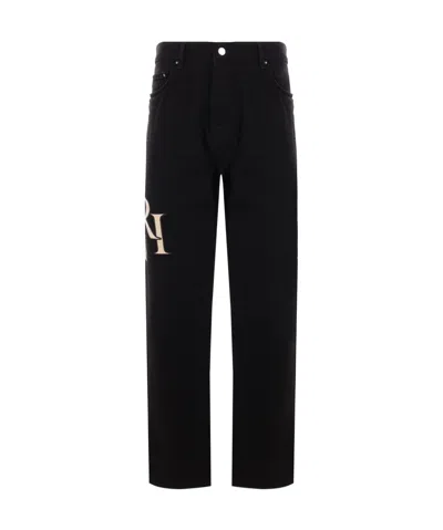 Amiri Staggered Logo Jeans In Black