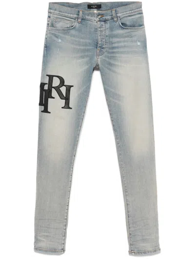 Amiri Staggered-logo Jeans In Blue