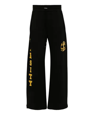 Amiri Flocked-logo Cotton Track Pants In Black