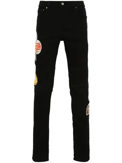 AMIRI TRAVEL PATCH REPAIR SKINNY JEANS