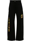 Amiri Flocked-logo Cotton Track Pants In Faded Black