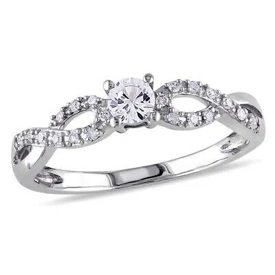 Pre-owned Amour Created White Sapphire And 1/10 Ct Tw Diamond Twist Promise Ring In 10k