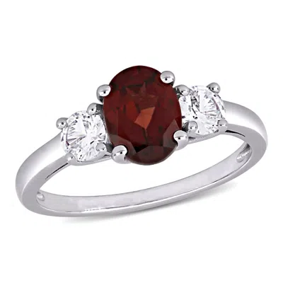 Amour Oval Cut Garnet And Created White Sapphire 3-stone Ring In Sterling Silver In ["white"]
