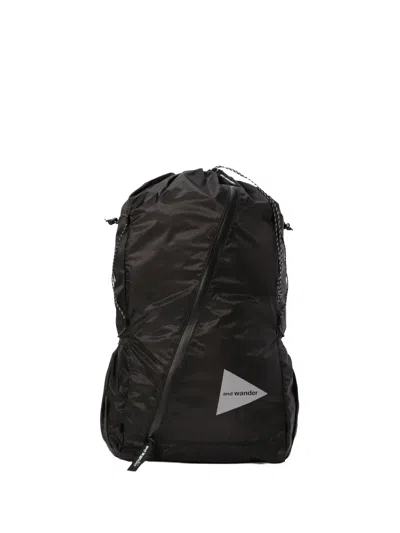 And Wander Drawstring Zip Backpack In Black