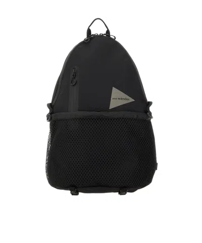 And Wander Logo Printed Backpack In Black