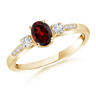 Angara Classic Oval Garnet And Round Diamond Three Stone Ring In Gold