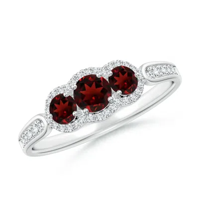 Angara Floating Three Stone Garnet Ring With Diamond Halo In Metallic