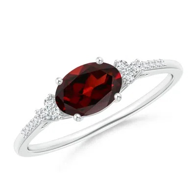 Angara Horizontally Set Oval Garnet Solitaire Ring With Trio Diamond Accents In Metallic