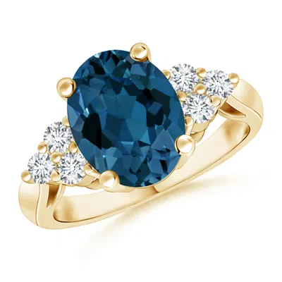 Angara Oval London Blue Topaz Cocktail Ring With Trio Diamonds In Gold