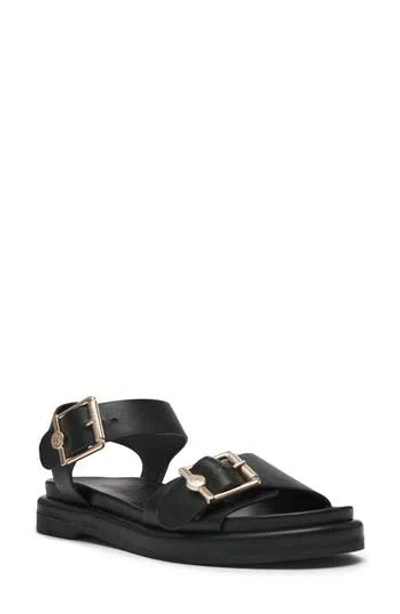 Anne Klein Elmer Flat Sandal In Black Nappa Pu