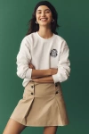 Shop Anthropologie Bride Tennis Club Crew-neck Embroidered Crest Sweatshirt