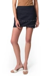 Apparis Bullet Crossover Studded Denim Miniskirt In Indigo