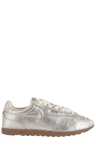 Autry Metallic Leather Windspin Sneakers In Gold