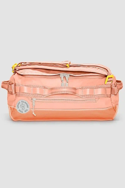 BABOON TO THE MOON GO-BAG DUFFLE MINI IN CORAL AT URBAN OUTFITTERS