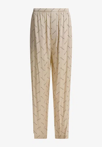 BALENCIAGA ALL-OVER LOGO PRINT PANTS