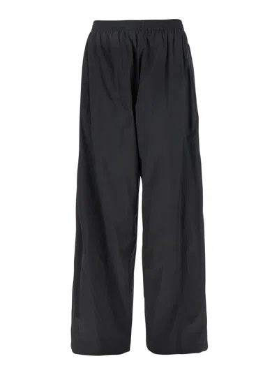 BALENCIAGA BLACK PANTS WITH ELASTIC DRAWSTRING AND SIDE BAND WITH LOGO LETTERING IN TECH FABRIC MAN
