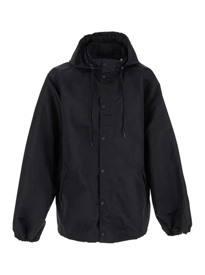 BALENCIAGA BLACK JACKET WITH DRAWSTRING HOOD AND MAXI LOGO LETTERING PRINT ON THE REAR IN TECH FABRIC MAN