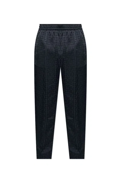 Balmain All-over Monogrammed Trousers In Black