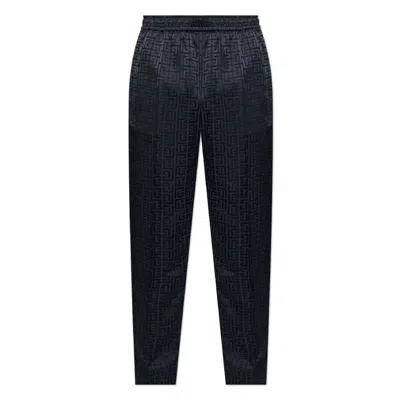 Balmain All-over Monogrammed Trousers In Black