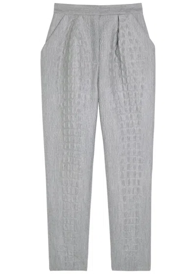Balmain Embossed Tapered-leg Trousers In Gray