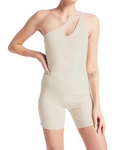 Bandier Asymmetric Tempo Short Catsuit In Pumice Stone In Neutral