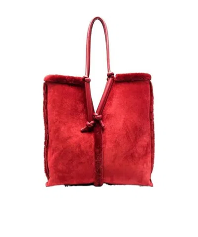 Bottega Veneta Bolster Reversible Shearling Suede Bag In Red