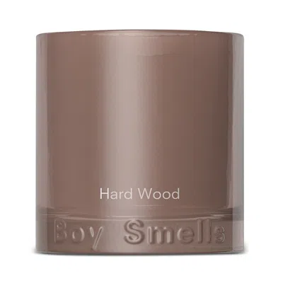 Boy Smells Hard Wood Candle In Brown