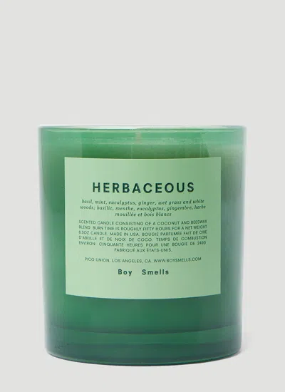 Boy Smells Herbaceous Candle In Green