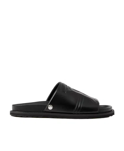 Burberry Embossed Monogram Motif Leather Slides In Black