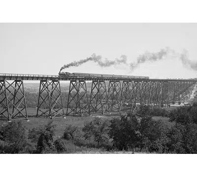 Buyenlarge Steam Train Passes Over Valley Trestle Bridge - Photograph Print In Black;gray