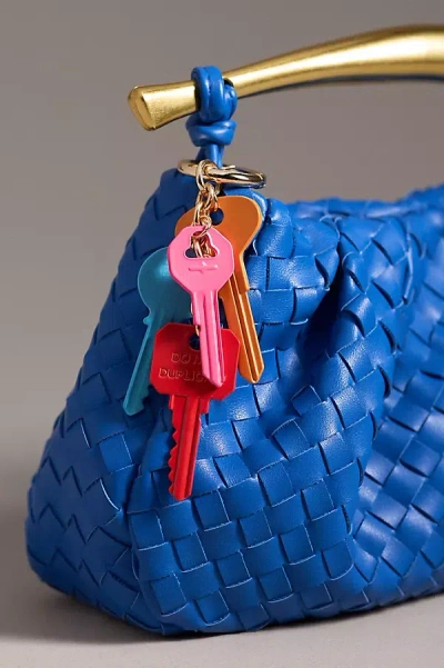 By Anthropologie Dangling Keys Bag Charm In Orange