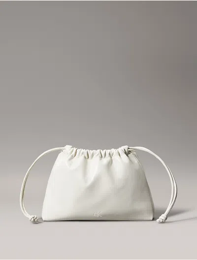 Calvin Klein Women's Monogram Logo Drawstring Crossbody Bag In Pelican