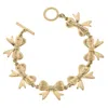 CANVAS STYLE WOMEN'S BOW LINKED TOGGLE BRACELET IN WORN GOLD
