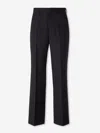 Carrer Cadore Trousers In Black