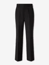 Carrer Cadore Trousers In Black