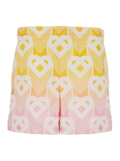 CASABLANCA ORANGE AND PINK BERMUDA SHORTS WITH LOGO ALL OVER IN TECHNO FABRIC MAN
