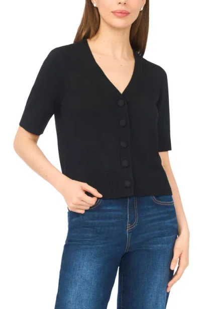 Cece Covered Button Short Sleeve Cardigan In Black
