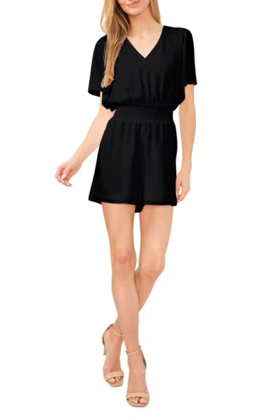 Cece Flutter Sleeve Smock Waist Romper In Rich Black