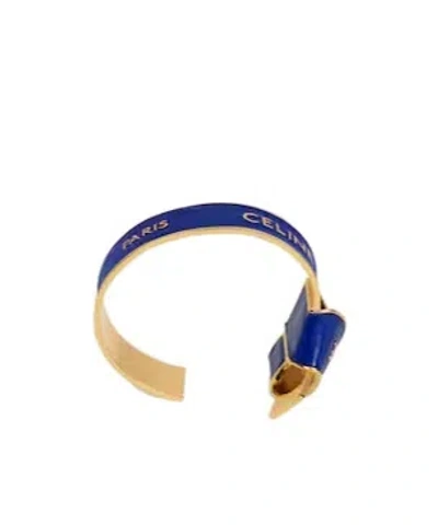 Celine Ribbon Knotted Cuff In Enamel And Brass With Gold Finish In Blue