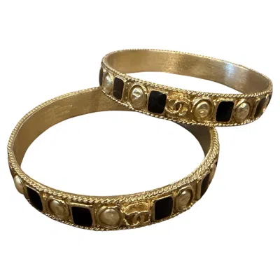 Pre-owned Chanel Two 1990s Iconic Gold Plated Metal And Black Enamel Bangle Bracelets By